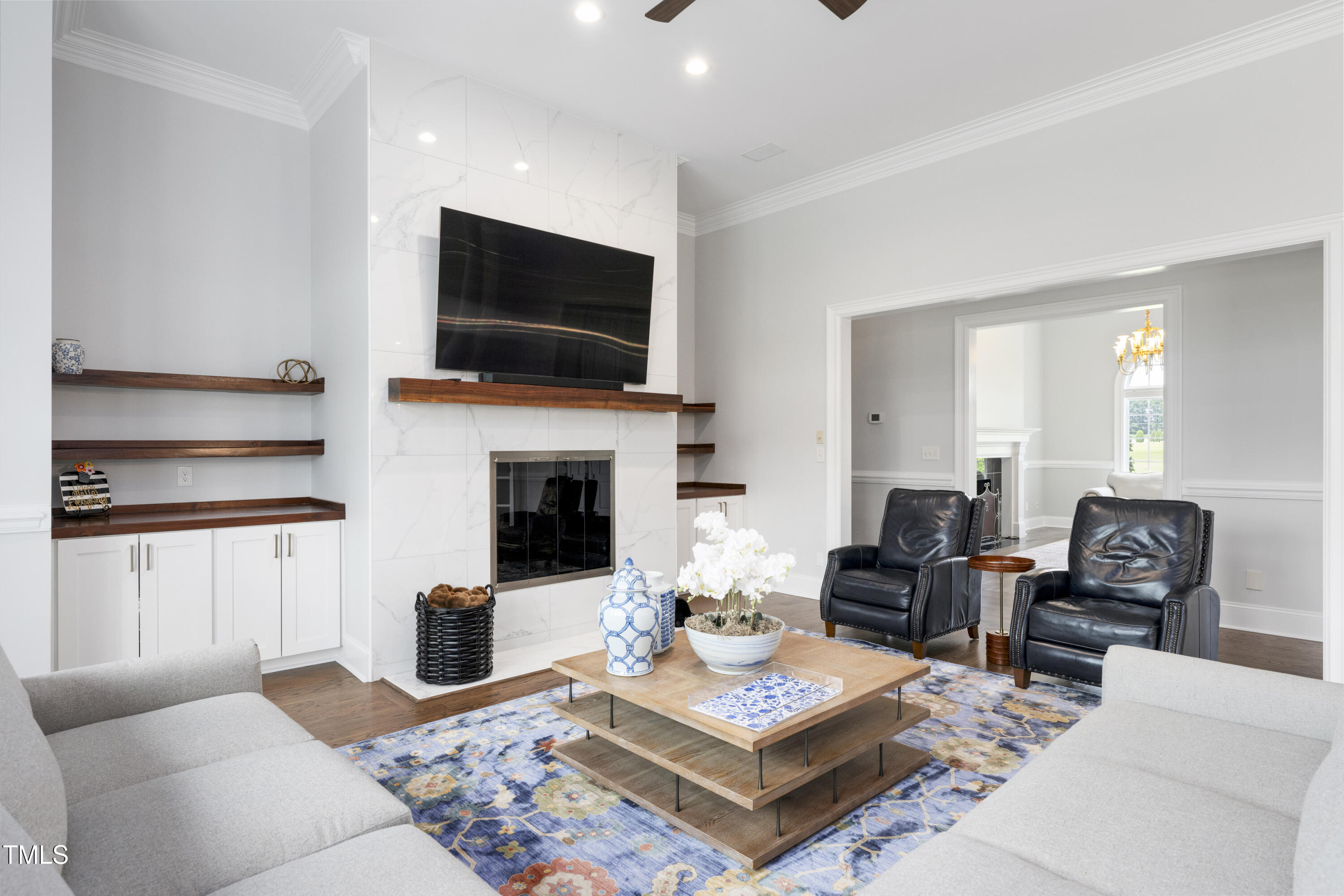 9820 Debnam Road Zebulon, NC 27597 - Photo 16 of 68 a living room with furniture a flat screen tv and a fireplace