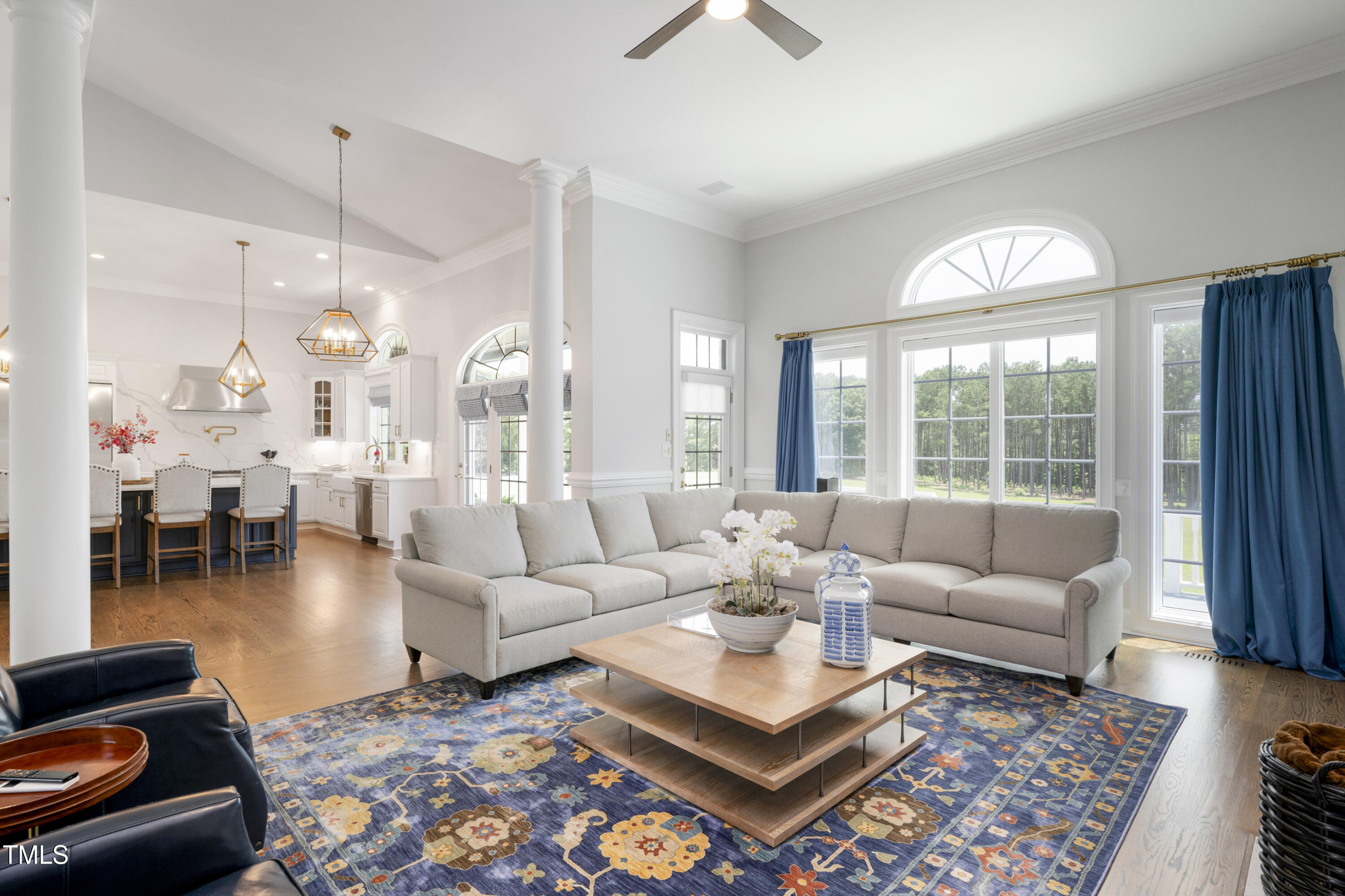 9820 Debnam Road Zebulon, NC 27597 - Photo 18 of 68 a living room with furniture a large window and a chandelier