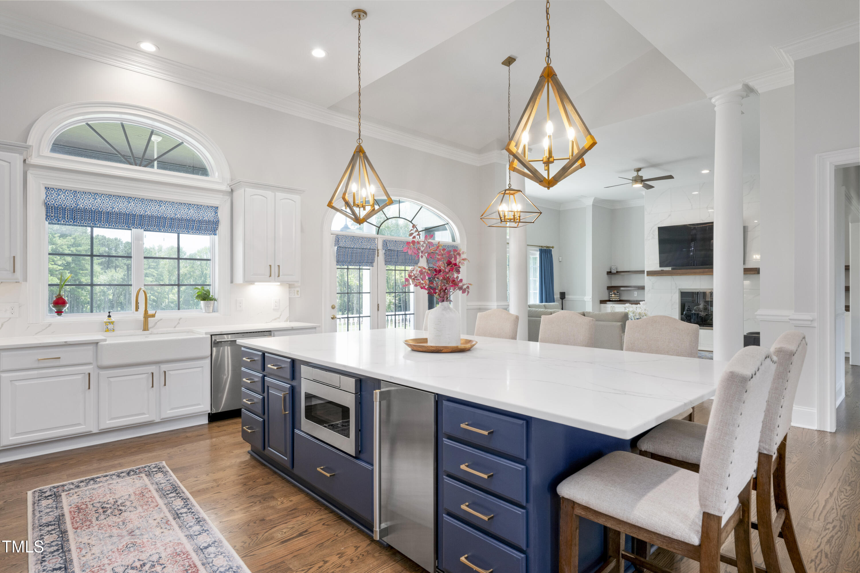 9820 Debnam Road Zebulon, NC 27597 - Photo 25 of 68 a large kitchen with stainless steel appliances a stove a chimney a sink and a large window