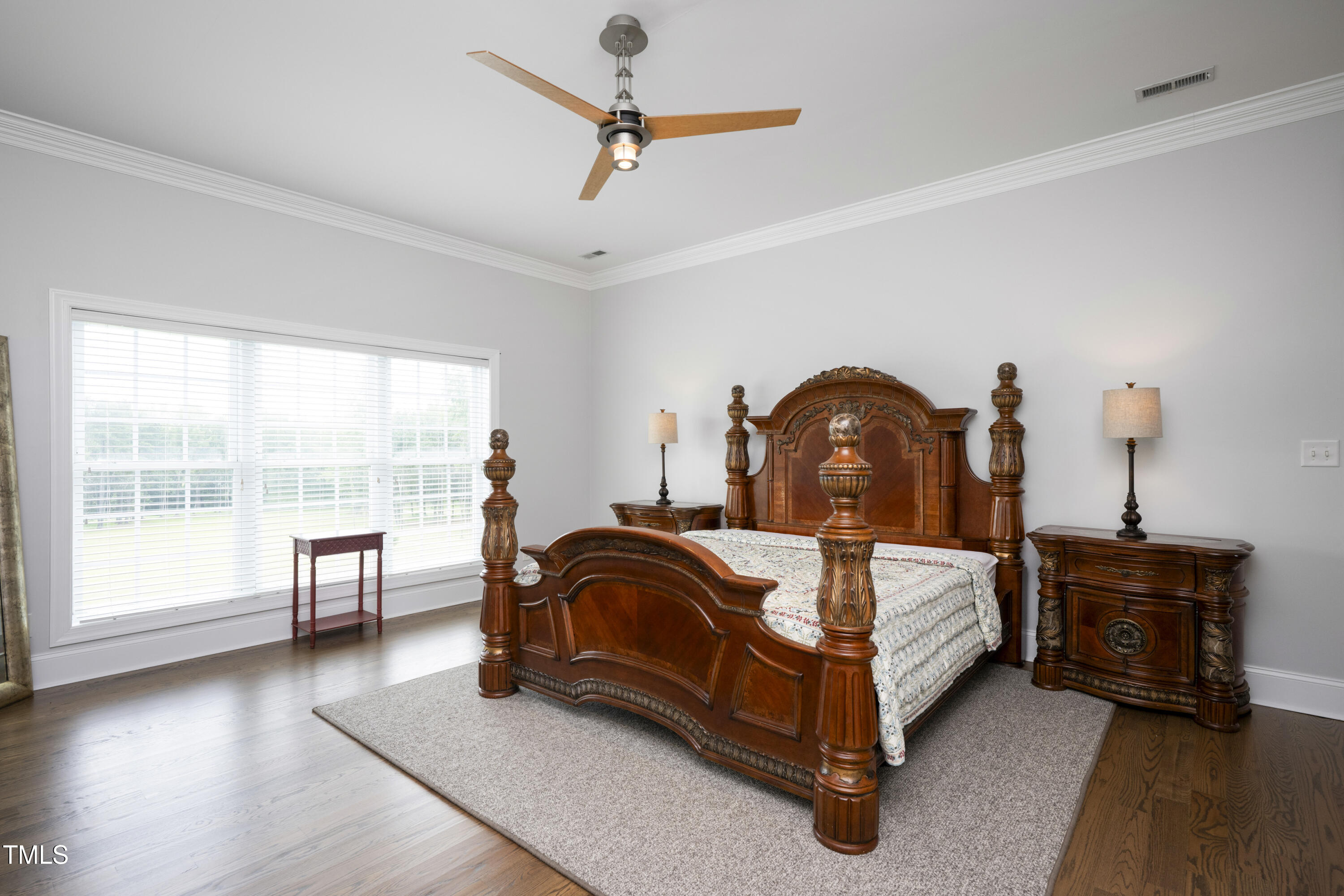 9820 Debnam Road Zebulon, NC 27597 - Photo 42 of 68 a bedroom with a bed and a chandelier