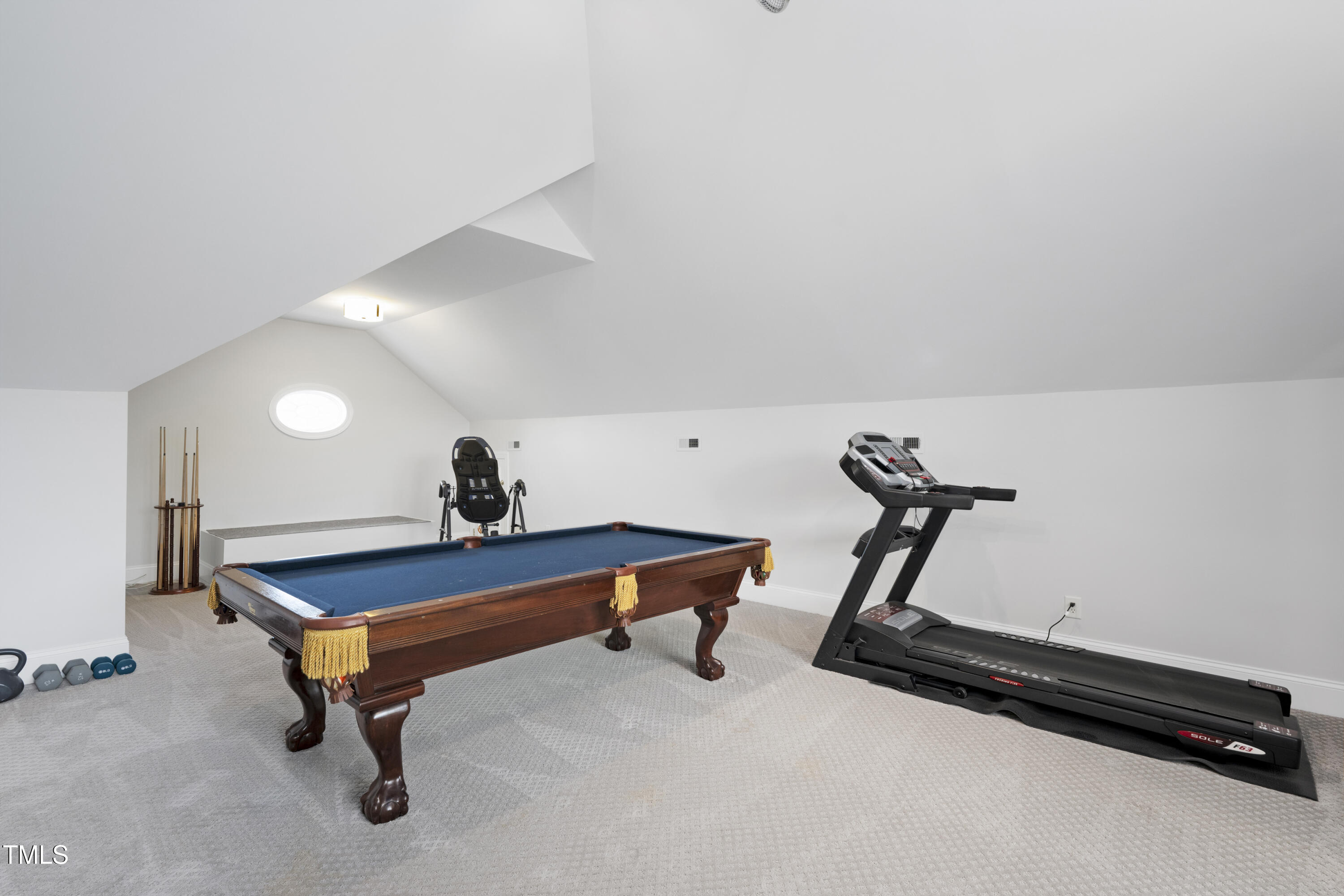 9820 Debnam Road Zebulon, NC 27597 - Photo 50 of 68 a living room with furniture gym equipment and a rug