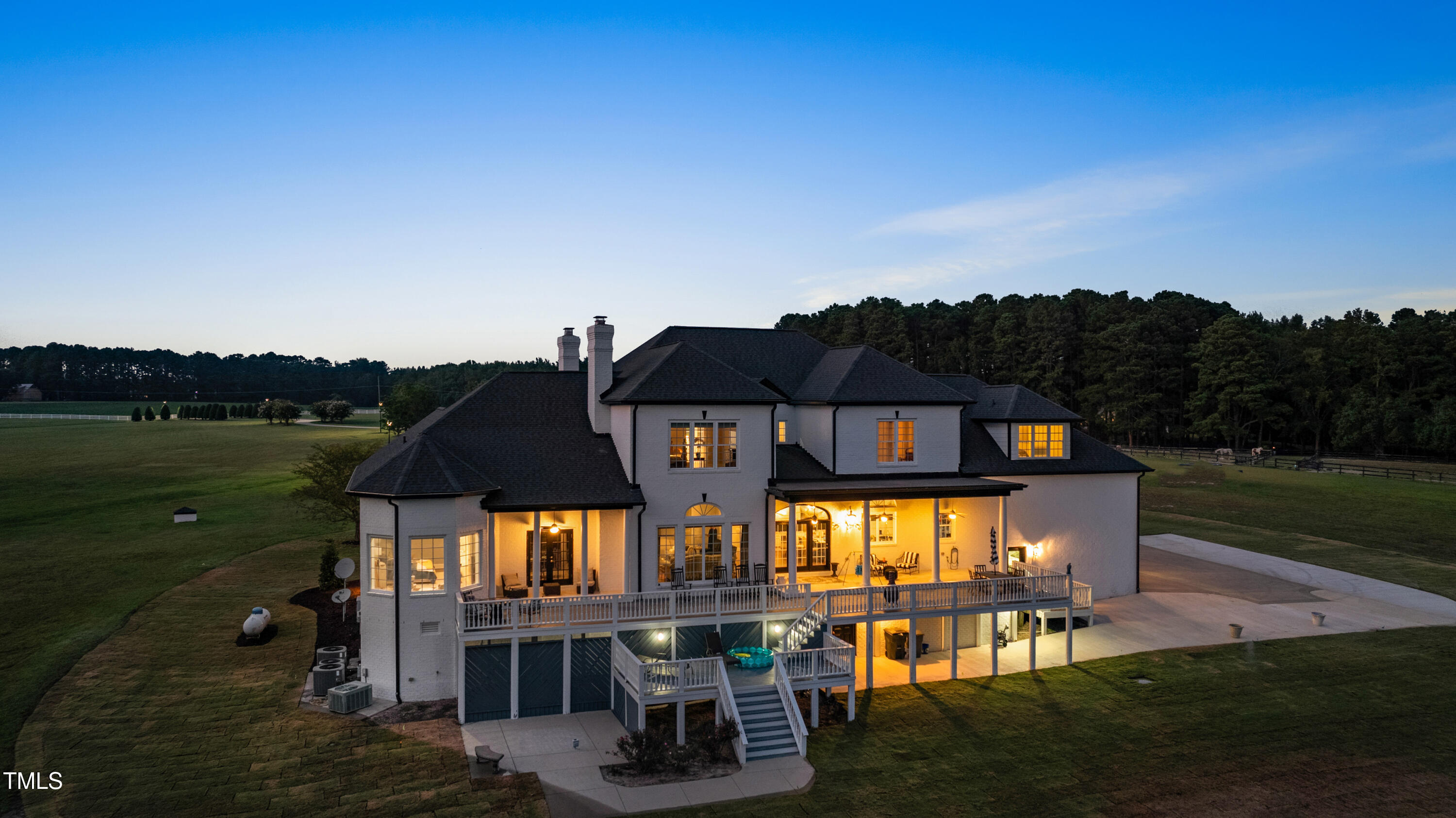 9820 Debnam Road Zebulon, NC 27597 - Photo 6 of 68 a view of a big house with a big yard and potted plants
