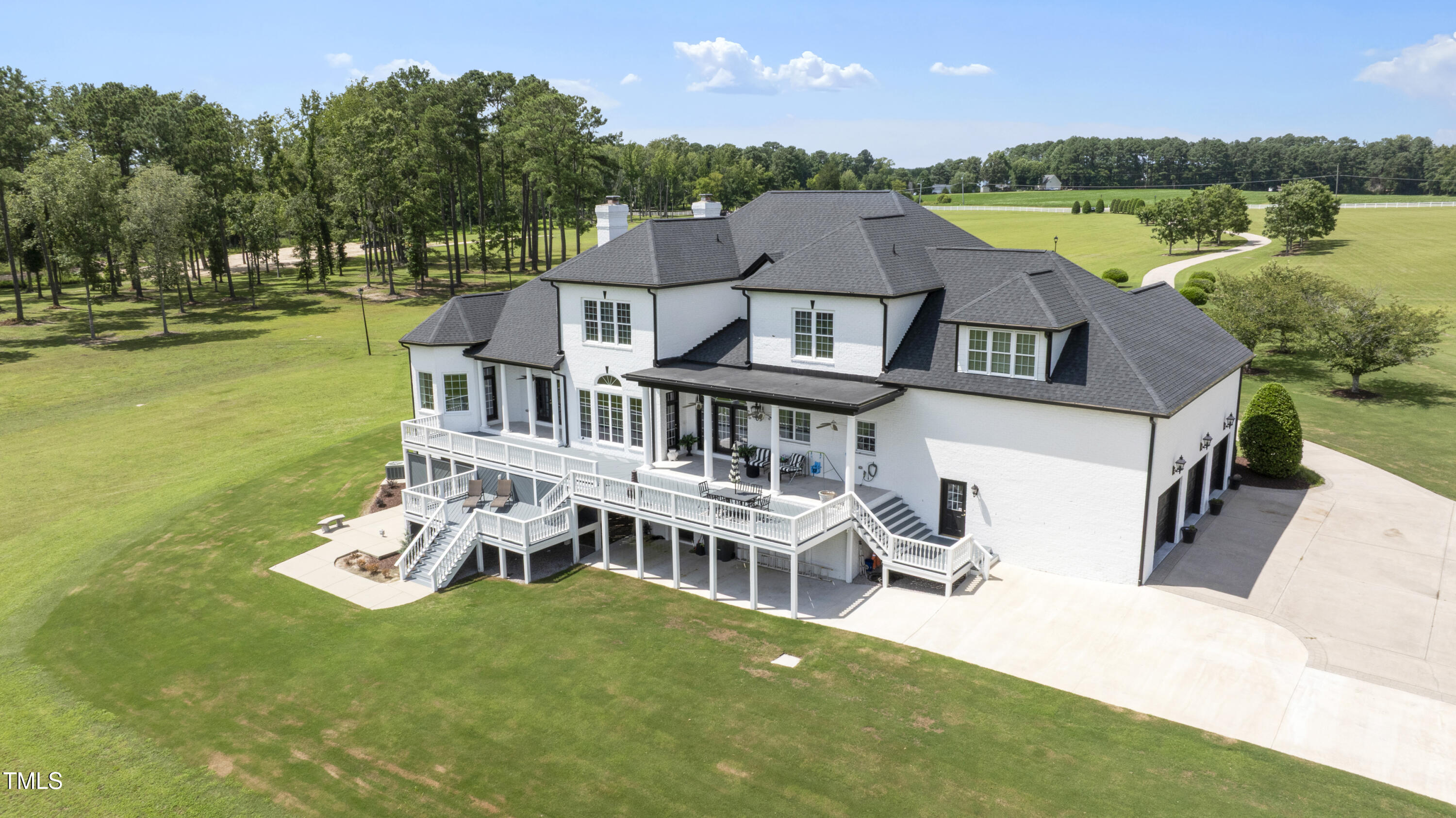 9820 Debnam Road Zebulon, NC 27597 - Photo 8 of 68 an aerial view of a house with a garden and lake view
