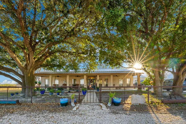 a view of a house with a backyard and a patio