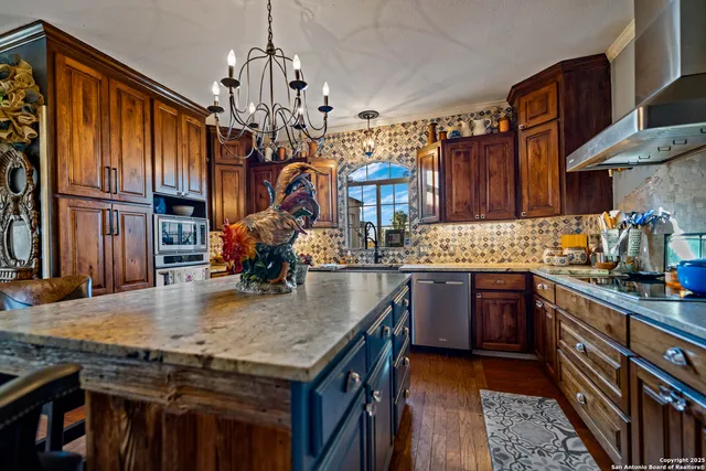 a living room with furniture a window and a chandelier