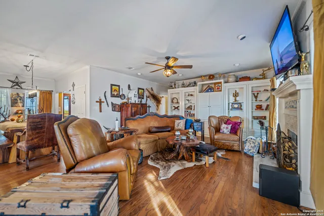 a living room with furniture a flat screen tv and a fireplace