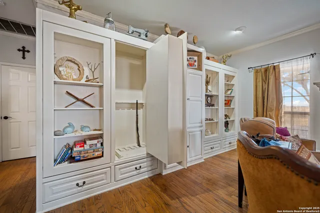 a bed room with a bed mirror and a chandelier