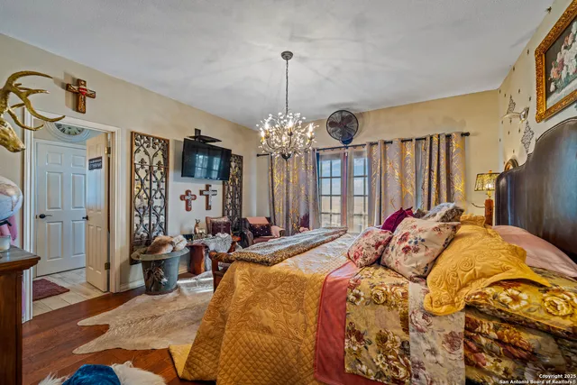 a bedroom with furniture and a chandelier