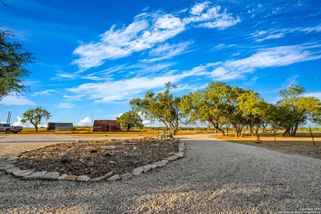 a view of swimming pool with seating area and trees around