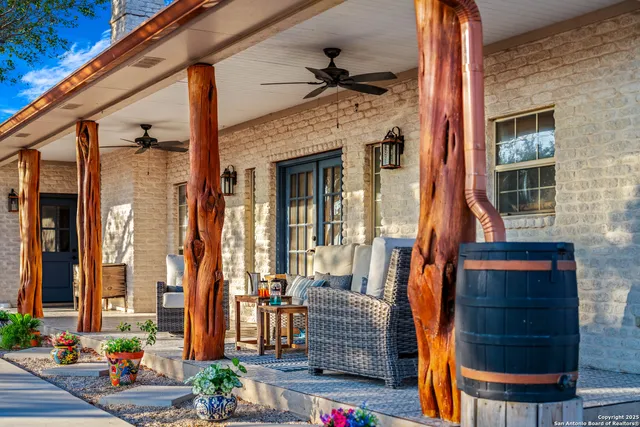a view of a patio with table and chairs and floor to ceiling window
