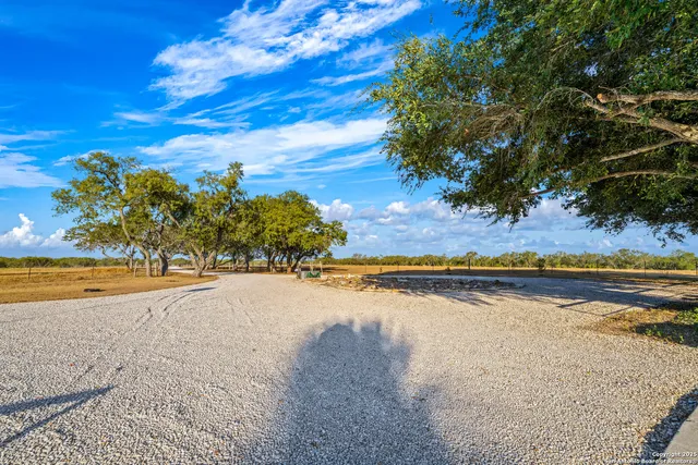 a view of a patio with table and chairs with wooden floor and fence