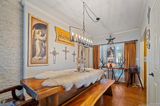 a kitchen with stainless steel appliances granite countertop a table chairs stove and wooden floor