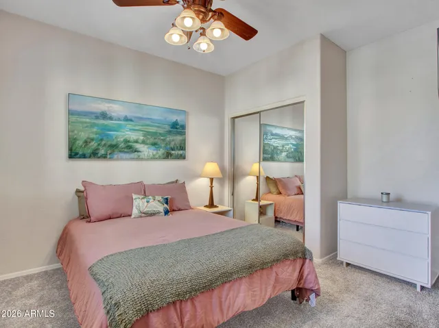 a bathroom with a granite countertop sink a toilet and shower