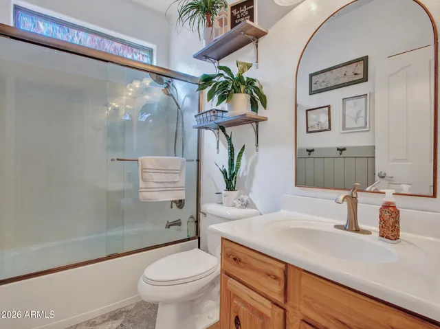 a view of a dining room and livingroom with furniture wooden floor and a chandelier