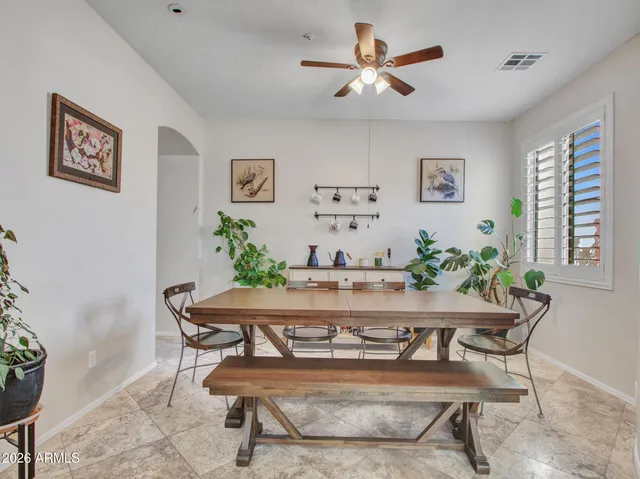 a living room with furniture a fireplace and a floor to ceiling window