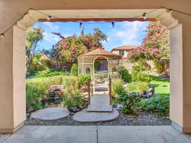 a view of a house with a big yard and potted plants