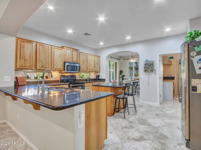 a living room with furniture fireplace and a large window