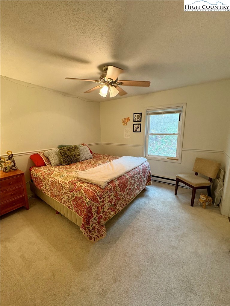 5416 Bamboo Road Boone, NC 28607 - Photo 19 of 35 a bedroom with a bed and a chandelier