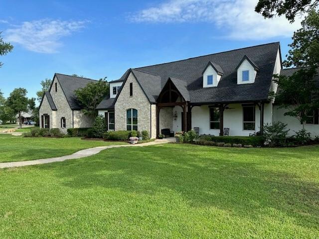 a front view of a house with a garden and deck