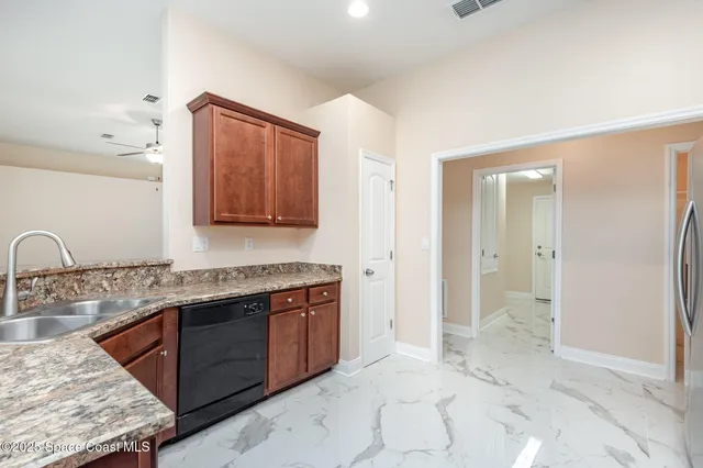 a spacious bathroom with a granite countertop sink a mirror and a shower