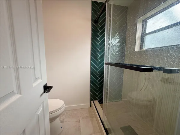 a bathroom with a shower and a toilet