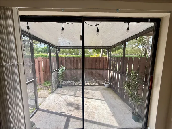 a porch with a glass door and glass door