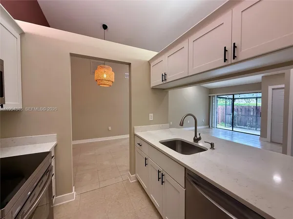 a kitchen with stainless steel appliances granite countertop a sink and a stove