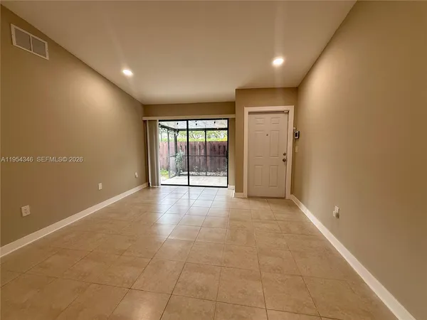 a view of an empty room with glass door