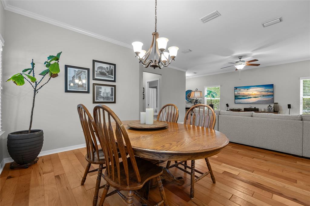 8251 Southwest 78th Lane Gainesville, FL 32608 - Photo 11 of 29 a view of a dining room with furniture and wooden floor