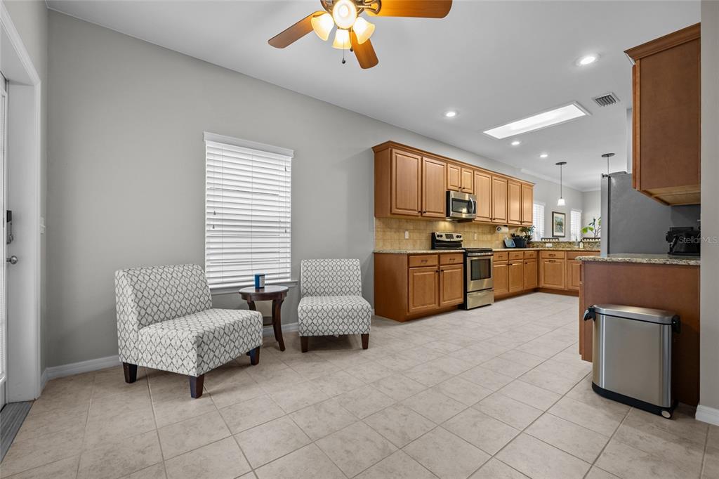 8251 Southwest 78th Lane Gainesville, FL 32608 - Photo 13 of 29 a kitchen with stainless steel appliances kitchen island granite countertop a refrigerator and a stove top oven