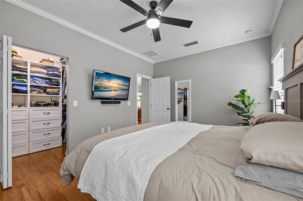 8251 Southwest 78th Lane Gainesville, FL 32608 - Photo 17 of 29 a bedroom with a bed a dresser and a flat screen tv