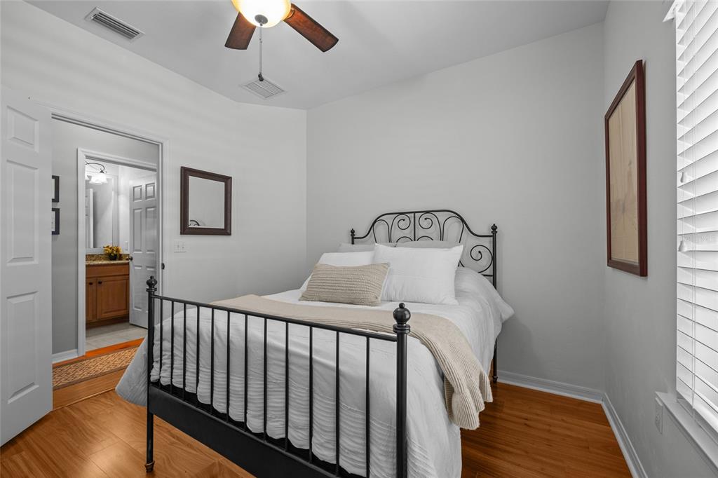 8251 Southwest 78th Lane Gainesville, FL 32608 - Photo 19 of 29 a bedroom with a bed and wooden floor