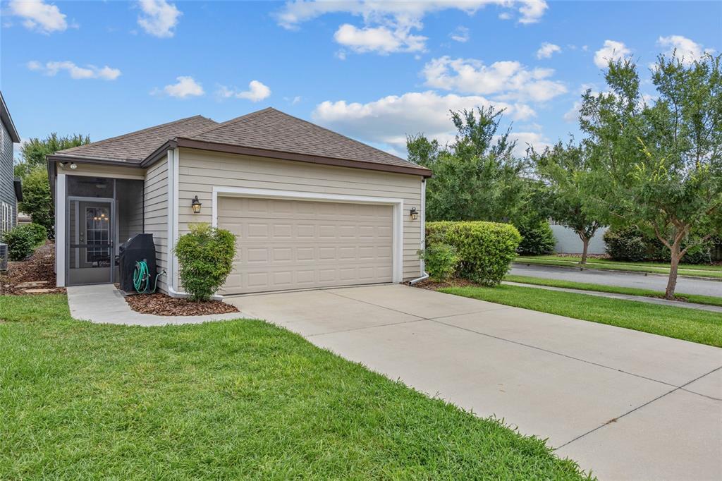 8251 Southwest 78th Lane Gainesville, FL 32608 - Photo 4 of 29 a front view of a house with a yard and garage