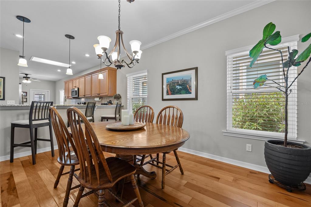 8251 Southwest 78th Lane Gainesville, FL 32608 - Photo 8 of 29 a view of a dining room with furniture a chandelier and wooden floor