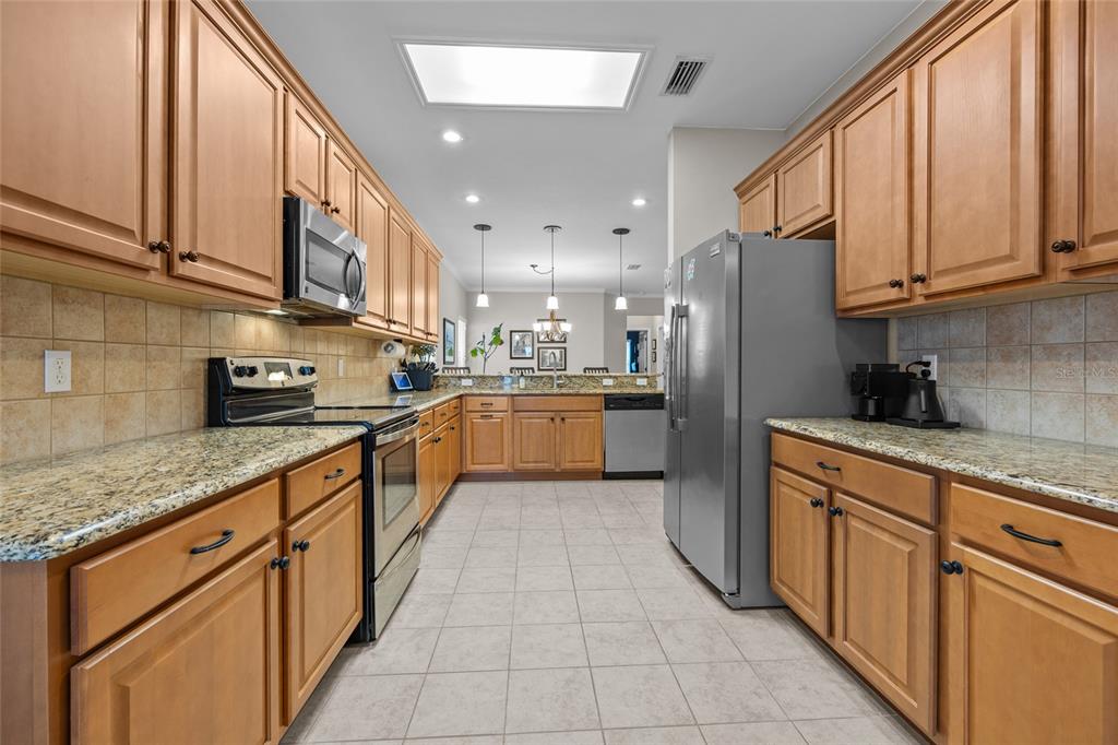 8251 Southwest 78th Lane Gainesville, FL 32608 - Photo 9 of 29 a kitchen with stainless steel appliances granite countertop a refrigerator and a sink