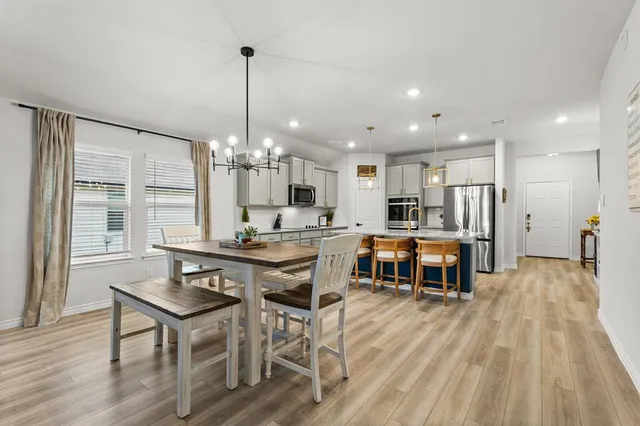 a view of a dining room with furniture window and wooden floor
