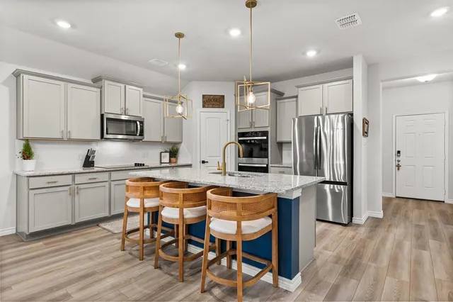 a kitchen with granite countertop a dining table and chairs