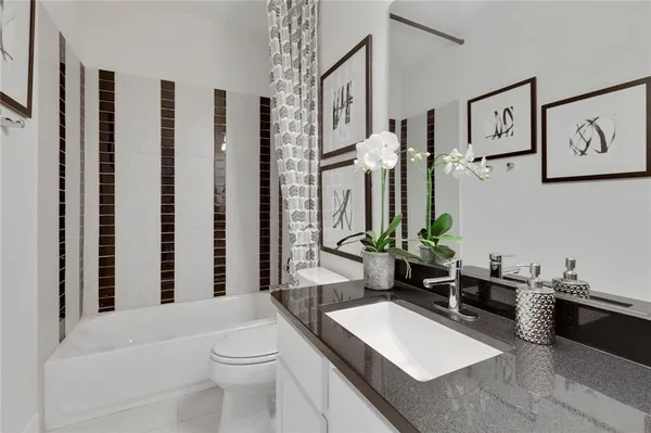 a bathroom with a toilet a sink and a mirror