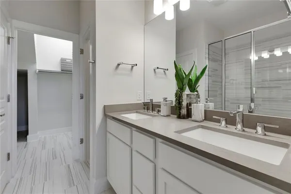 a bathroom with a double vanity sink and a mirror