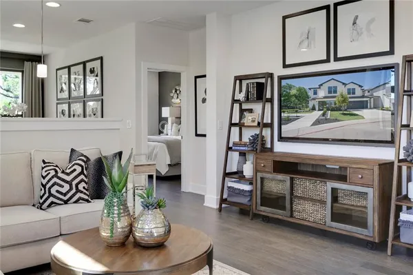 a living room with furniture and wooden floor