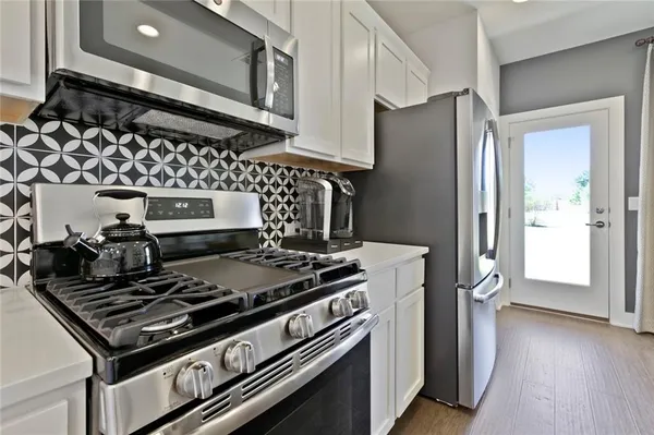 a stove top oven sitting inside of a kitchen