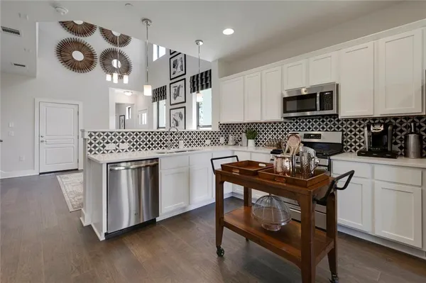 a kitchen with a sink cabinets and window