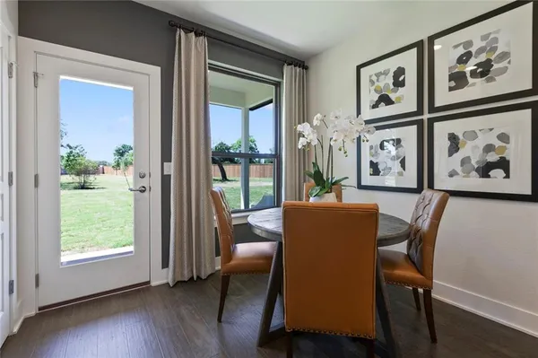 a dining room with furniture and wooden floor