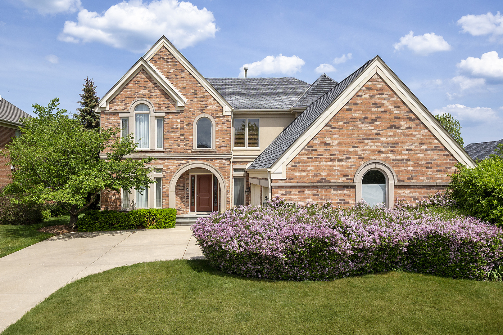 a front view of a house with a garden