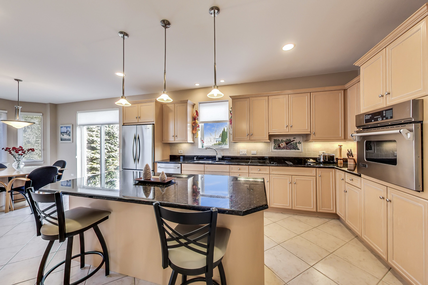 791 Endicott Road Highwood, IL 60040 - Photo 7 of 25 a kitchen with stainless steel appliances granite countertop a stove a sink a refrigerator a dining table and chairs