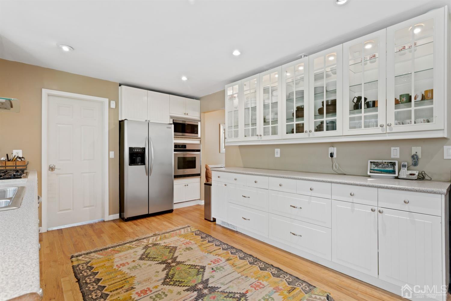 3 Rider Place West Windsor, NJ 08550 - Photo 12 of 33 a kitchen with granite countertop white cabinets and refrigerator