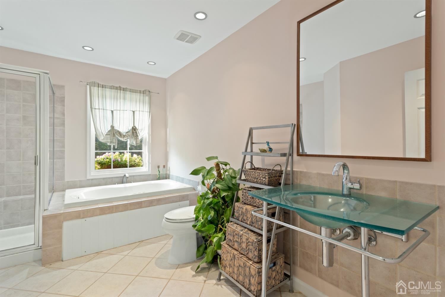 3 Rider Place West Windsor, NJ 08550 - Photo 19 of 33 a bathroom with a granite countertop sink a large mirror a vanity and next to a window