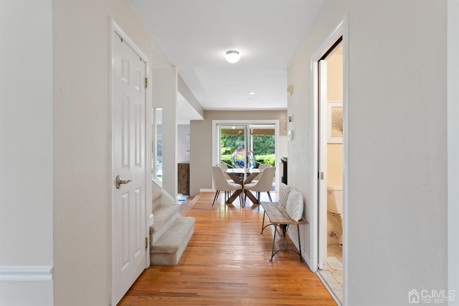 3 Rider Place West Windsor, NJ 08550 - Photo 3 of 33 a view of a hallway with wooden floor and a living room