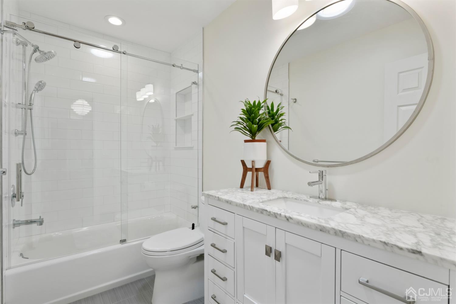 3 Rider Place West Windsor, NJ 08550 - Photo 25 of 33 a bathroom with a granite countertop sink a toilet and shower