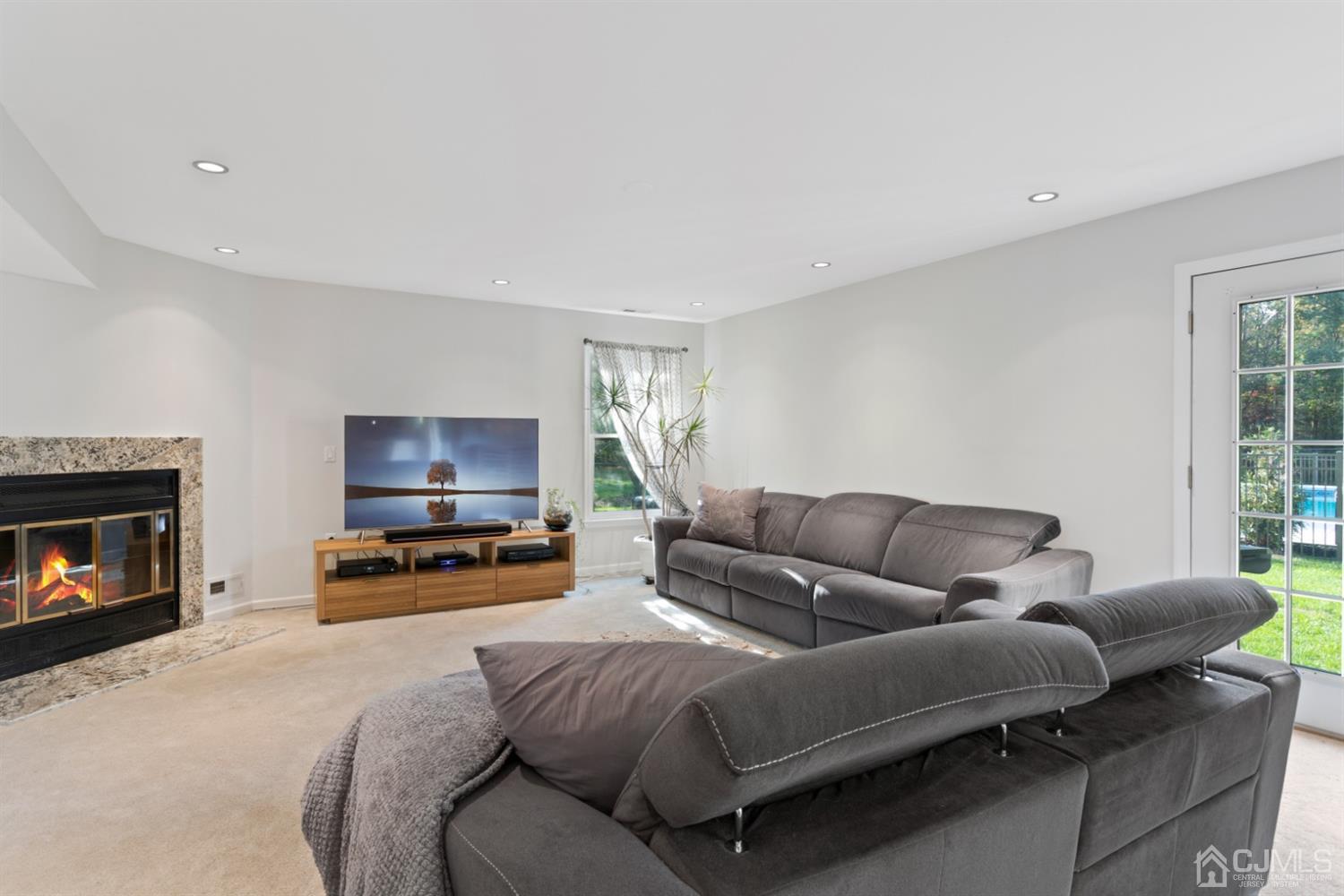 3 Rider Place West Windsor, NJ 08550 - Photo 7 of 33 a living room with furniture a flat screen tv and a fireplace